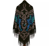 Black shawl with floral  design and fringe on a white background