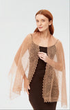Gossamer light brown knitted shawl draped over shoulders. Warm, lightweight dark beige pashmina wrap for winter.