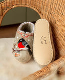 A pair of thick, hand-felted woolen loafers for women, showcasing expert craftsmanship and heavy-duty indoor quality. The toe area is embroidered with a detailed cluster of textured red rowan berries and bullfinch bird, tied together by matching orange hand-stitching along the rim.