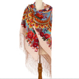 Premium quality cashmere shawl wrapping on a manequin with bright red colors and long fringe.