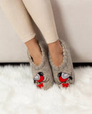 Gray woolen Slavic slippers with bullfinch bird designs worn by a person on a white surface