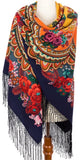 A high-quality product photograph of a large, square woolen colorful scarf displayed against a solid white background. The scarf features a clean multicolor base adorned with a vibrant, multicolored Slavic pattern of oversized vintage red rose flowers and detailed boho-style paisley framing, finished with long, delicate matching fringes.