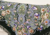 Floral patterned woolen scarf with fringes on a light background
