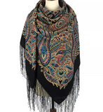 Turquoise paisley patterned black wrapping scarf with fringes on a mannequin against a white background