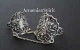 A picture showing a spider net goth style double ring with Armenian Spirit title on a black surface.