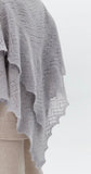 A stylized flat-lay arrangement showcasing the cozy grey goat down winter scarf
