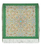 Green fringed shawl with intricate patterns on a green background