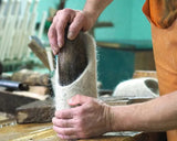 A photo showing a process of felted slippers handwoven.