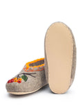 A pair of handwoven woolen slippers with rubber outsole.
