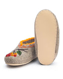 Pair of slippers with floral design on a white background