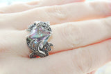 Ring with a small, faceted green gemstone made from silver on a hand25 and marcasite 