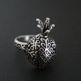 Silver pomegranate-shaped Armenian ring with traditional carpet design on a dark background