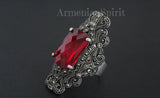 Ring with a red gemstone and intricate silver design on a dark background, featuring 'Armenian Spirit' branding.