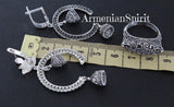 Silver jewelry pieces on a ruler with 'Armenian Spirit' branding.