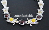 Crafted with high quality sterling silver, this handmade bracelet boasts a luxurious gold-plated design and vibrant gemstones including yellow jadeite and red natural garnet. Each piece is stamped with 925 for authenticity. Elevate your style with this geometric jewelry piece.
