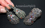 Feather large earrings with colorful stones on a dark background, featuring the brand 'Armenian Spirit'.