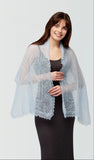 Soft winter wrapping featuring a knitted light blue pashmina shawl with fine lace knitting on a woman's shoulders.