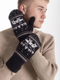 A man wearing black knit winter gloves with white and brown Nordic-style patterns and a polar bear, posed against a clean white background.