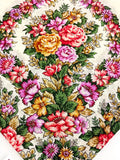 Colorful floral patterned woolen shawl on a white background