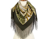 Green scarf with animal print and fringes on a mannequin against a white background