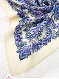 Floral patterned merino wool shawl with blue and purple flowers on a white background