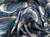Close-up of patterned shawl with blue, red, and white colors.