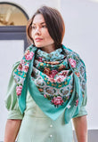 Woman wearing a pink vintage floral scarf with a teal border