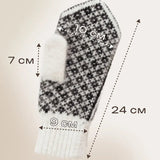 A single knit mitten shown on a light beige background with overlaid dimension arrows and text indicating measurements: 10 cm width, 7 cm finger depth, 9 cm cuff width, and 24 cm overall length. The mitten has a black-and-white houndstooth pattern with a white finger and white ribbed cuff.