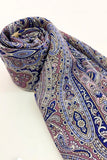 Roll of woolen navy blue and purple  shawl with a paisley indian  pattern on a white background