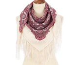 Paisley patterned white woolen Slavic scarf with fringe and wine red pattern on a mannequin against a white background