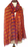 Colorful patterned very long merino wool scarf on a mannequin