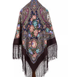 Colorful peach floral and paisley patterned woolen shawl palatine with fringes on a white background