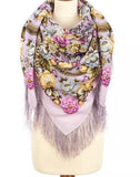 Floral patterned pale purple scarf with fringes on a mannequin against a white background