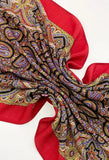 Red woolen Slavic shawl with yellow and blue paisley pattern on a white background