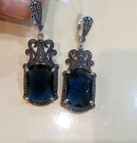 marcasite long earrings-with navy blue-faceted stones on ivory surface.