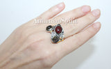 Silver ring featuring natural garnet and labradorite gray gemstones, with gold plating on the metal.