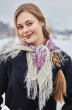 Woman wearing a patterned merino wool white and purple scarf with fringes 