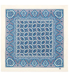Blue and white patterned fabric square on a beige background