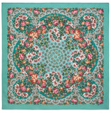 Floral patterned square merino wool scarf on a teal background