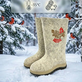 A pair of light gray Slavic felt valenki boots standing in a snowy winter forest, featuring a thick frost-resistant beige and brown TR outsole platform with an anti-slip grip pattern. Seamless 100 percent natural sheep wool felt boots designed for extreme cold up to minus 35 degrees Celsius, standing on a snow-covered path surrounded by pine trees.