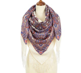 Patterned woolen white Slavic scarf with fringes on a mannequin against a white background