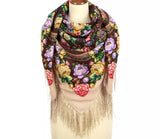 Colorful brown and beige multicolor floral-patterned scarf with fringes on a mannequin against a white background