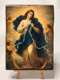 Handcrafted wooden icon of Mary Undoer of Knots resting on a miniature wooden display easel. Our Lady Untier of Knots Catholic religious painting printed on a solid wood block panel.