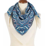 Blue paisley scarf on a mannequin with a white background