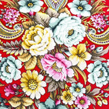 Colorful floral and paisley patterned merino wool  shawl on a red background