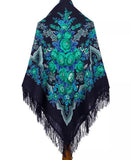 Navy blue large merino wool shawl with green flowers  and fringes on a white background