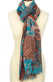 Patterned brown and turquoise women winter scarf draped over a mannequin on a white background