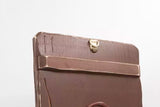 A brown ico cover styled like an old icon, standing on a small wooden display stand against a white background.