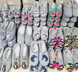 Collection of gray medical woolen slippers with various designs on a shelf.