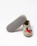 Pair of slippers with a bird design on a white background